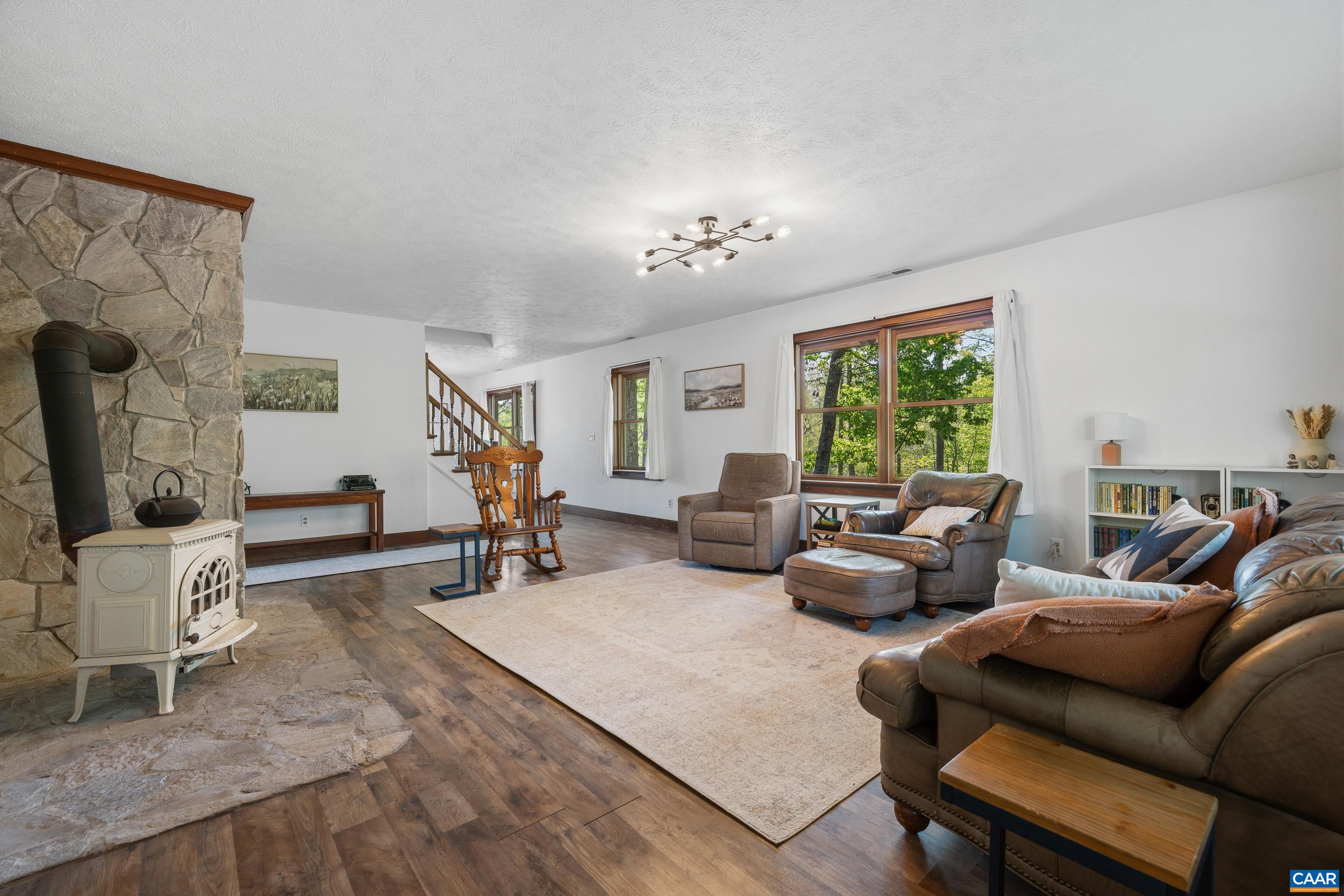 2947 Merrie Meadows Lane Keswick, VA 22947 - Photo 30 of 75 a living room with furniture and a flat screen tv