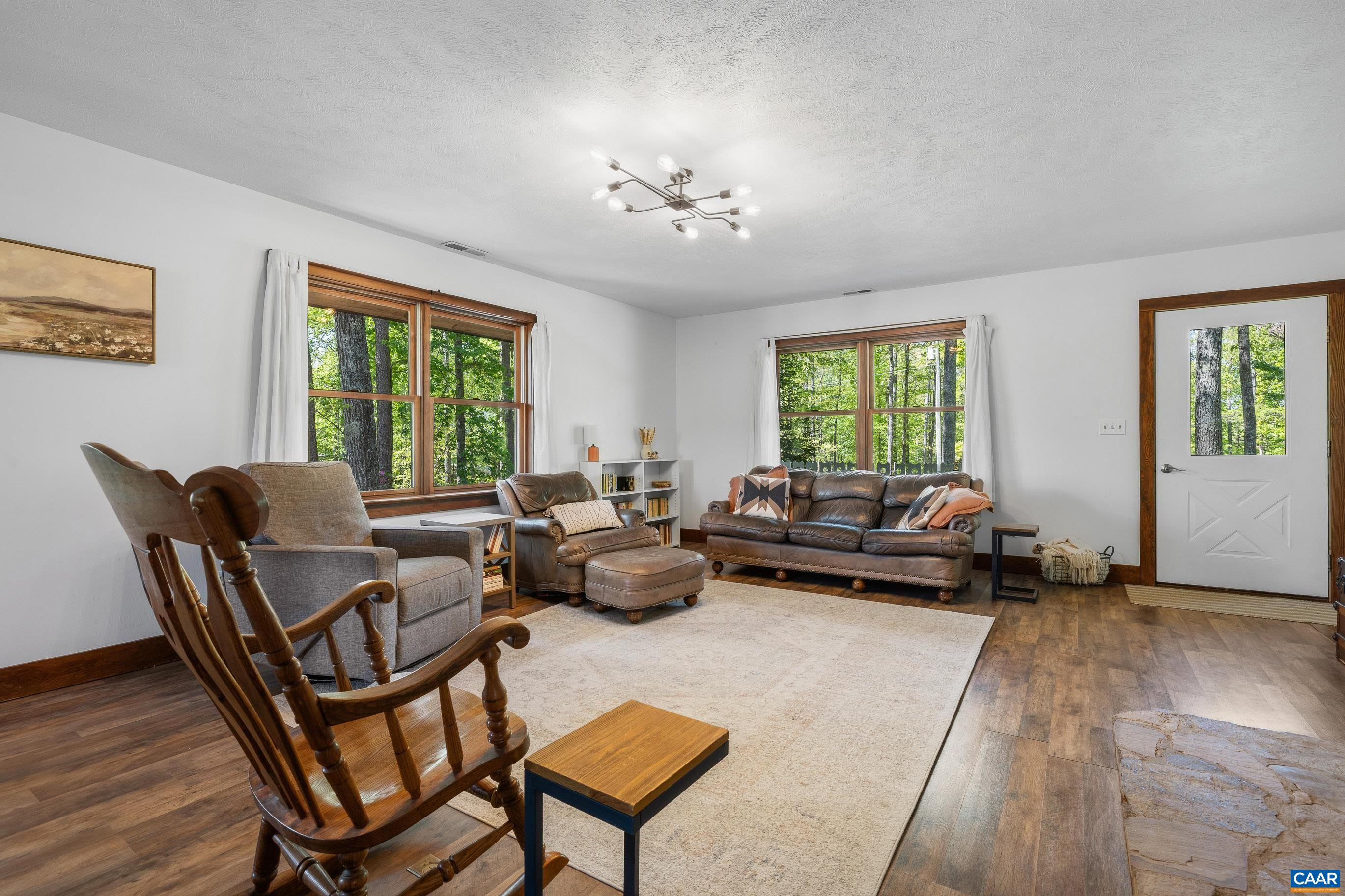 2947 Merrie Meadows Lane Keswick, VA 22947 - Photo 31 of 75 a living room with furniture and a chandelier