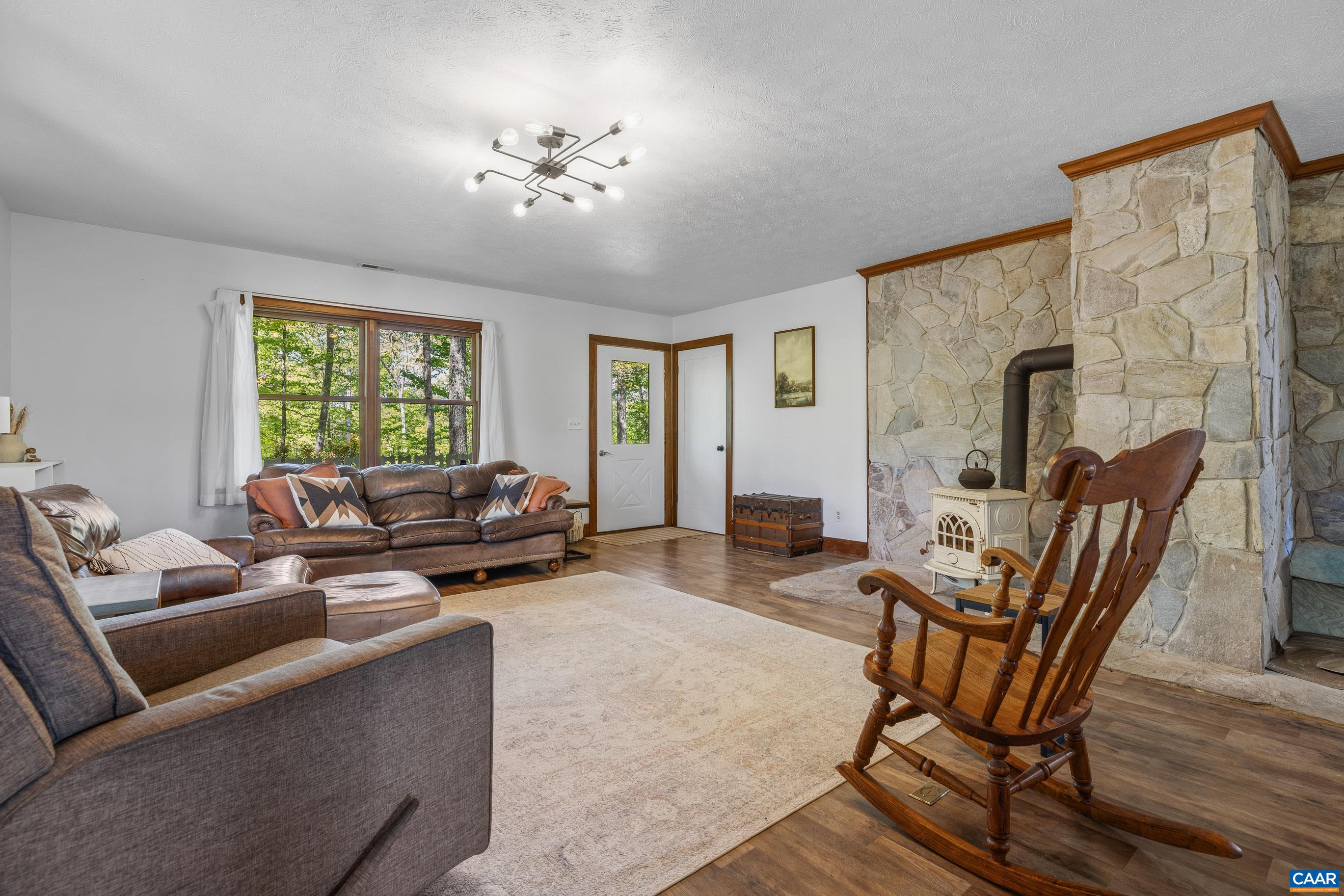 2947 Merrie Meadows Lane Keswick, VA 22947 - Photo 32 of 75 a living room with furniture and a chandelier