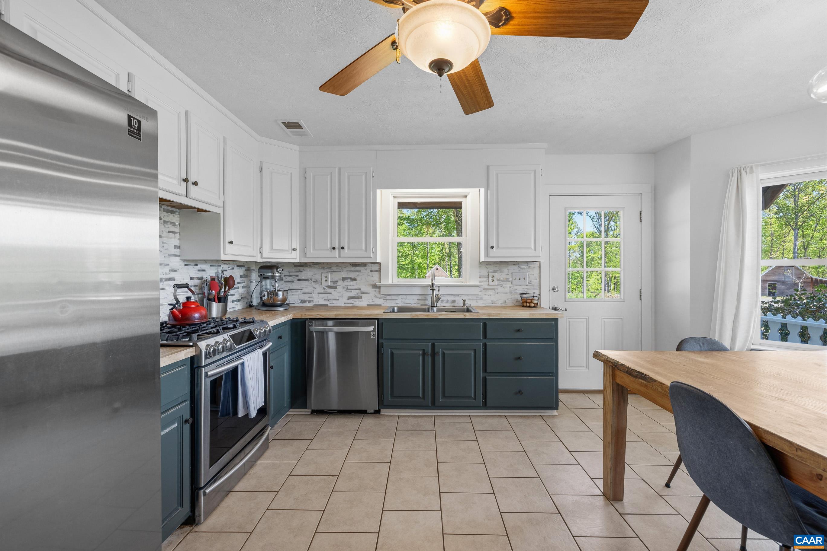 2947 Merrie Meadows Lane Keswick, VA 22947 - Photo 40 of 75 a kitchen with a stove window and cabinets
