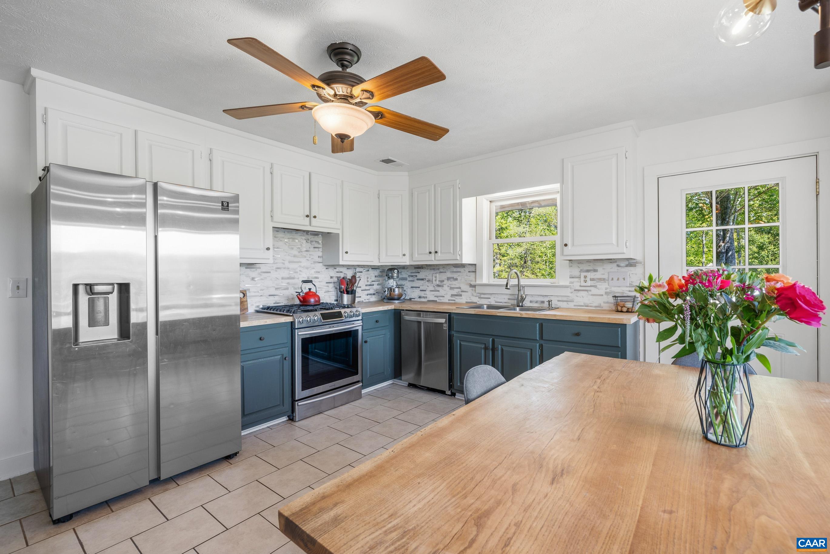 2947 Merrie Meadows Lane Keswick, VA 22947 - Photo 41 of 75 a kitchen with stainless steel appliances kitchen island granite countertop a refrigerator a sink a stove a microwave and cabinets