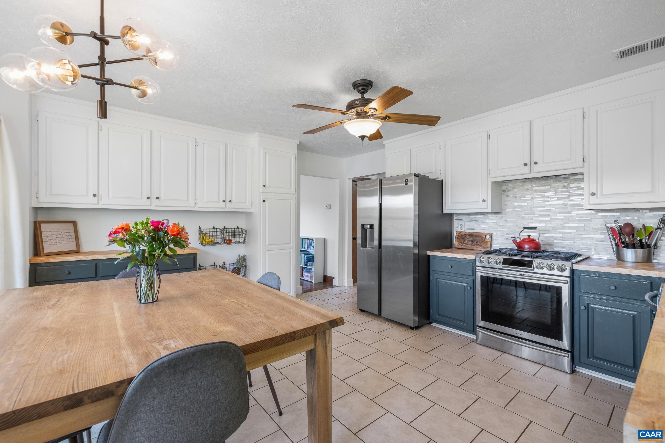 2947 Merrie Meadows Lane Keswick, VA 22947 - Photo 42 of 75 a kitchen with stainless steel appliances kitchen island a table chairs in it and a window