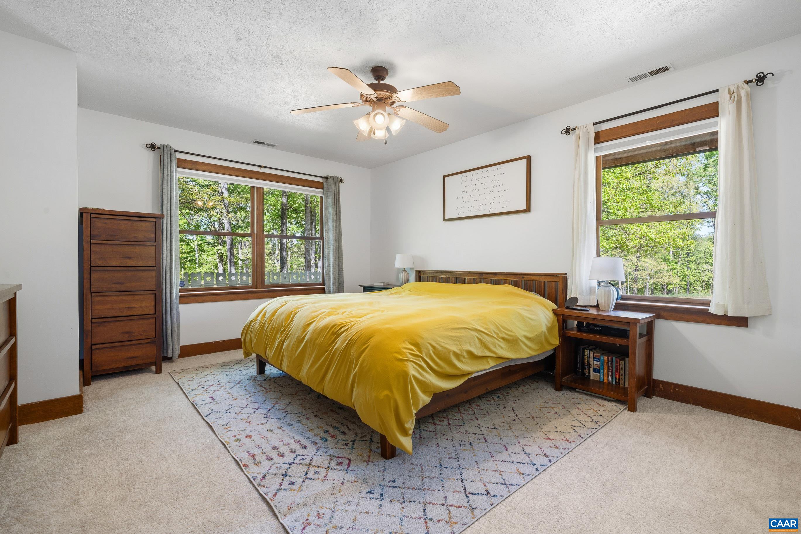 2947 Merrie Meadows Lane Keswick, VA 22947 - Photo 44 of 75 a bed sitting in a bedroom next to a window