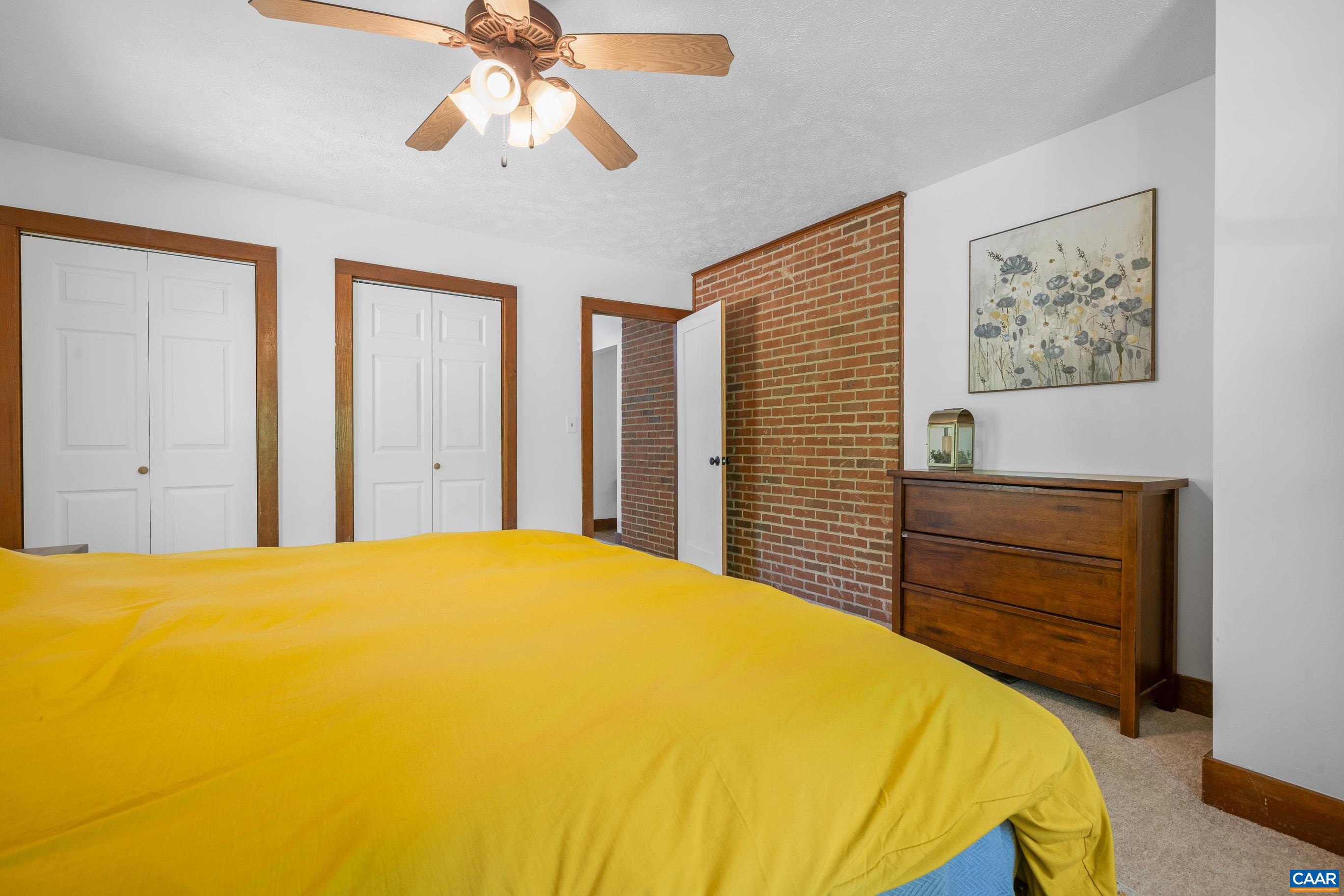 2947 Merrie Meadows Lane Keswick, VA 22947 - Photo 45 of 75 a bedroom with a bed and a chandelier