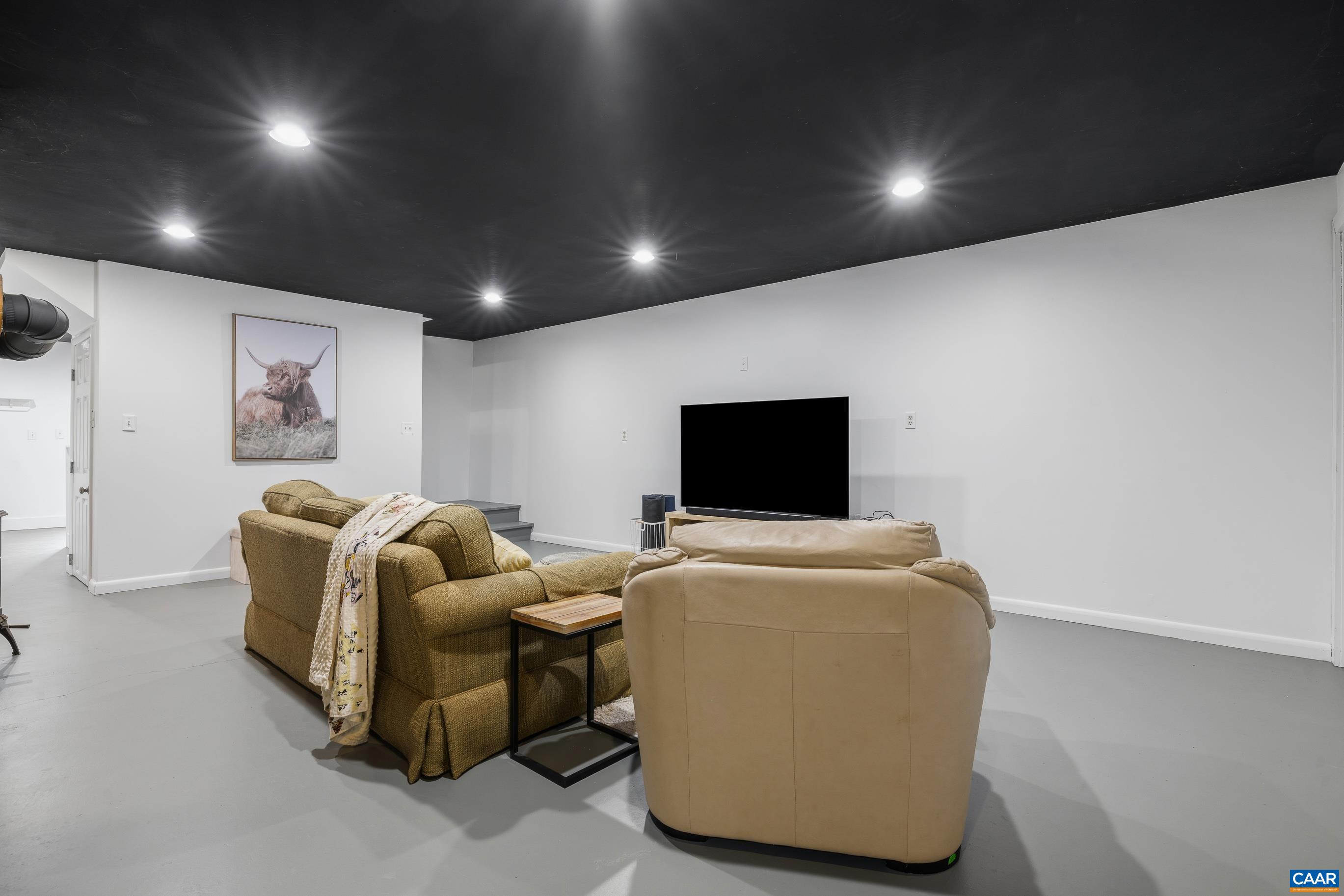 2947 Merrie Meadows Lane Keswick, VA 22947 - Photo 54 of 75 a living room with furniture and a flat screen tv