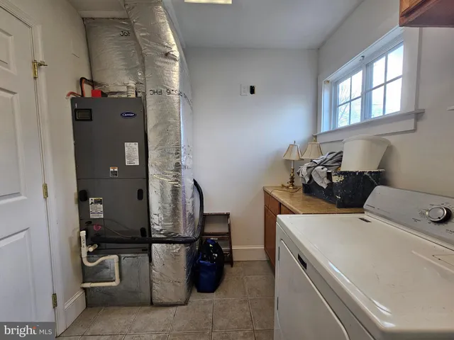 a bathroom with a tub a sink and a large mirror