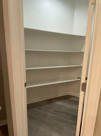 a bathroom with a bathtub shower sink vanity mirror and toilet