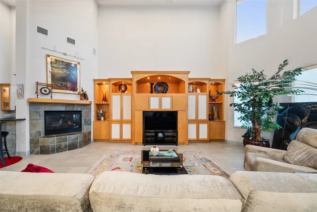 a living room with furniture gym equipment and a fireplace