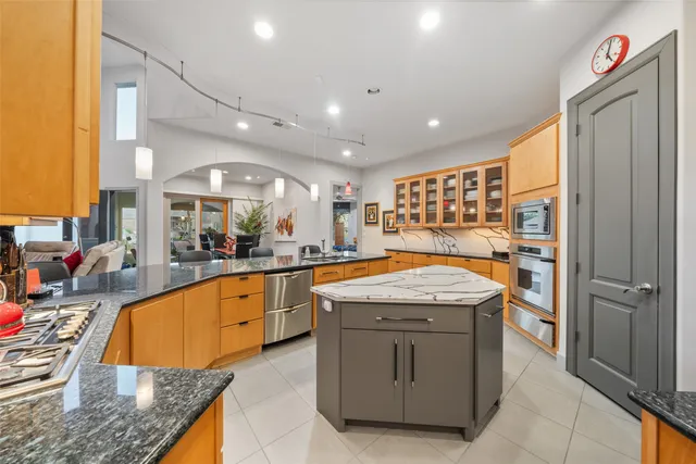 a kitchen with stainless steel appliances granite countertop a sink stove and refrigerator