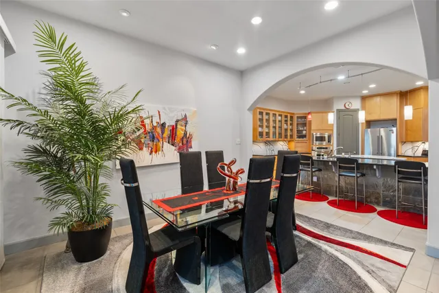 a living room with a bed furniture flat screen tv and couches