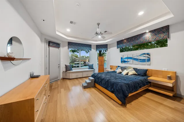 a spacious bedroom with a large bed a desk and chair