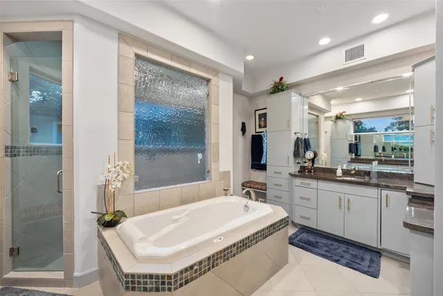 a bathroom with a sink toilet vanity and shower