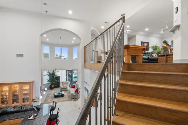 a room with pool table and windows