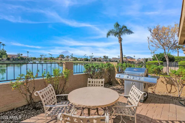 a view of a patio with table and chairs and potted plants