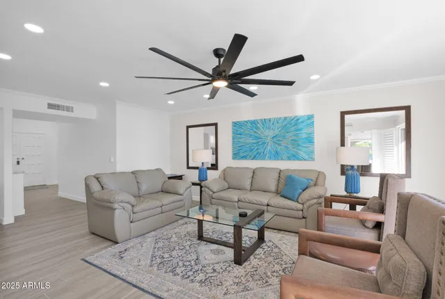 a living room with furniture and a large window