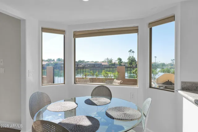 a dining room with furniture and a large window