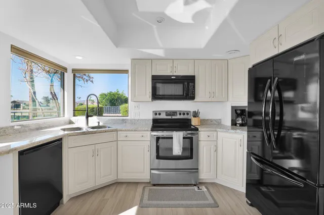 a kitchen with a sink stove and refrigerator