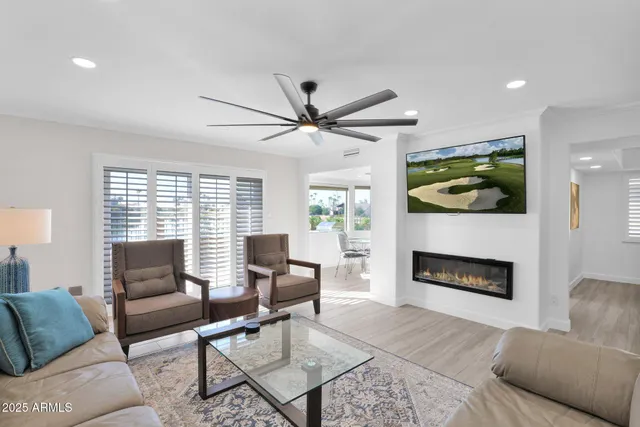 a living room with furniture fireplace and window