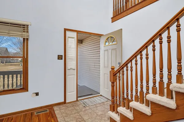 a view of an entryway with wooden floor