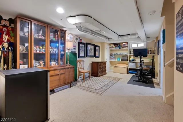 a bedroom with furniture a flat screen tv and a large window