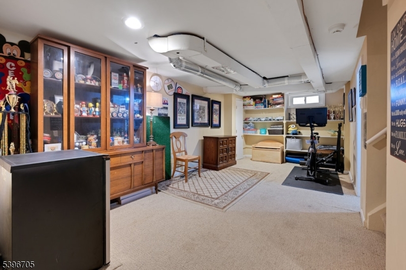 3 Maple Way Mountain Lakes, NJ 07046 - Photo 20 of 28 a bedroom with furniture a flat screen tv and a large window