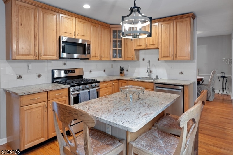 3 Maple Way Mountain Lakes, NJ 07046 - Photo 25 of 28 a kitchen with a table chairs microwave and cabinets