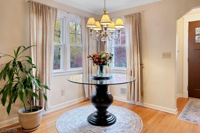 a vase of flowers sitting on a table with a fireplace