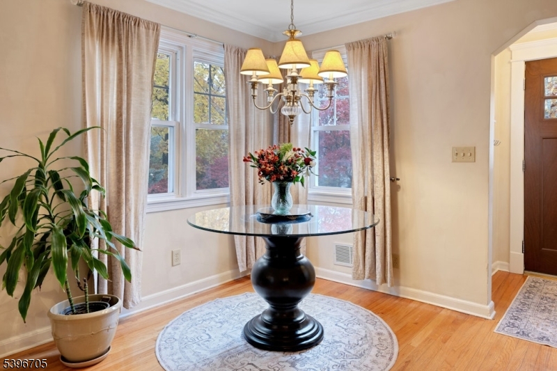 3 Maple Way Mountain Lakes, NJ 07046 - Photo 26 of 28 a vase of flowers sitting on a table with a fireplace