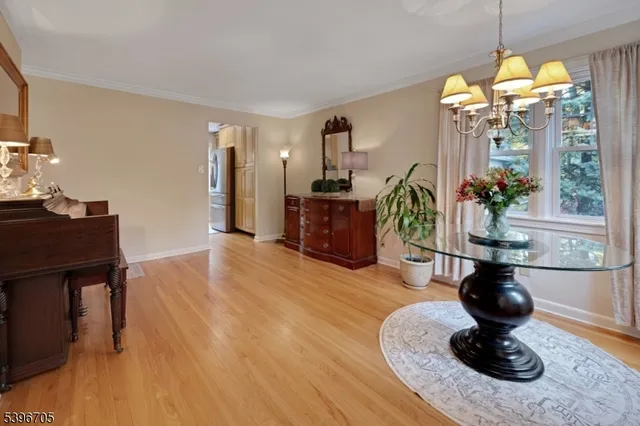 a living room with fireplace furniture and a chandelier