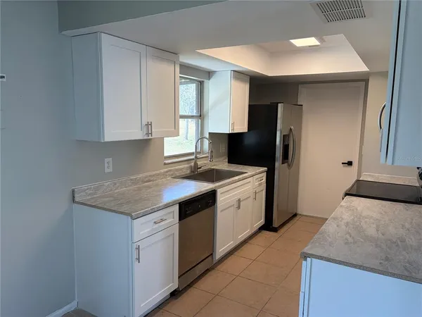 a kitchen with a sink stove and refrigerator