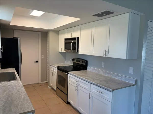 a kitchen with a sink stove and refrigerator