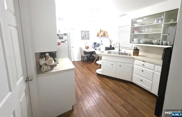 a kitchen with sink and cabinets
