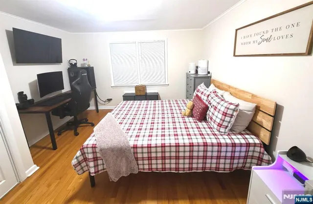 a bedroom with a bed and flat screen tv