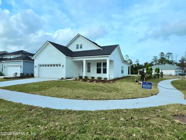 a view of a house with a yard patio and fire pit