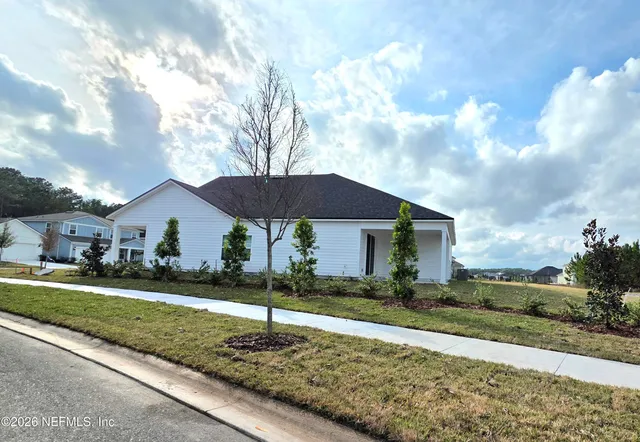 a front view of a house with a yard