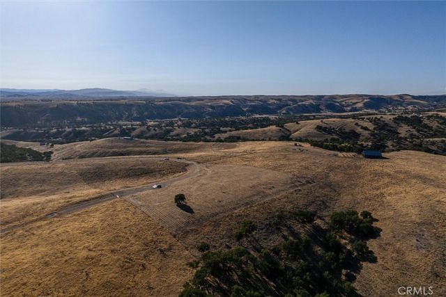 an aerial view of mountain with yard