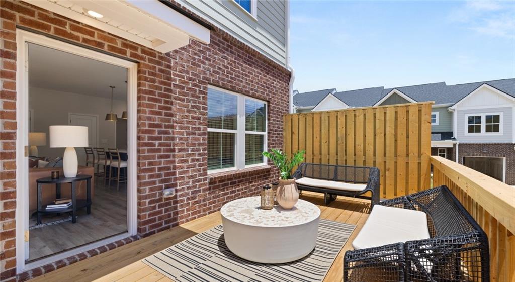 100 Rosemoore Drive Covington, GA 30014 - Photo 22 of 41 a balcony with table and chairs