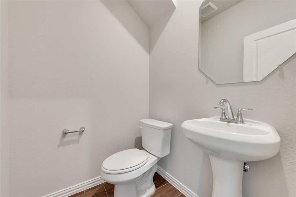 261 Sutter Mill Road Saginaw, TX 76131 - Photo 16 of 24 a bathroom with a sink toilet and a mirror