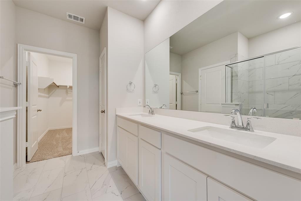 261 Sutter Mill Road Saginaw, TX 76131 - Photo 18 of 24 a bathroom with a sink and a mirror