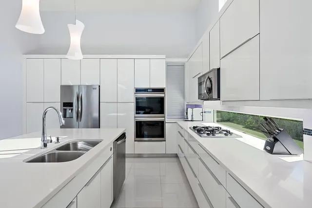 a bathroom with a double vanity sink a mirror a bathtub and shower