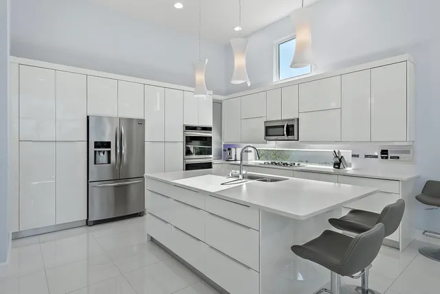 a bedroom with a bed a dresser next to a window