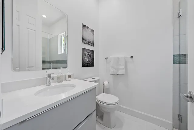 an aerial view of residential houses with outdoor space and lake view