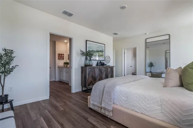 a bedroom with a bed and a potted plant