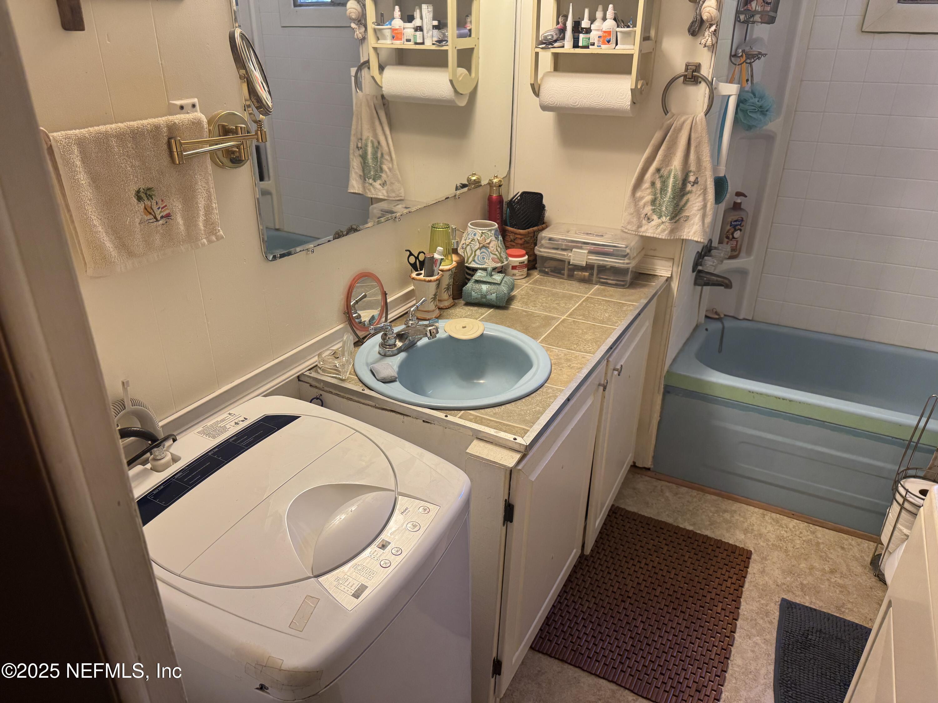 208 Lakeview Road Melrose, FL 32666 - Photo 16 of 22 a bathroom with a sink and a mirror