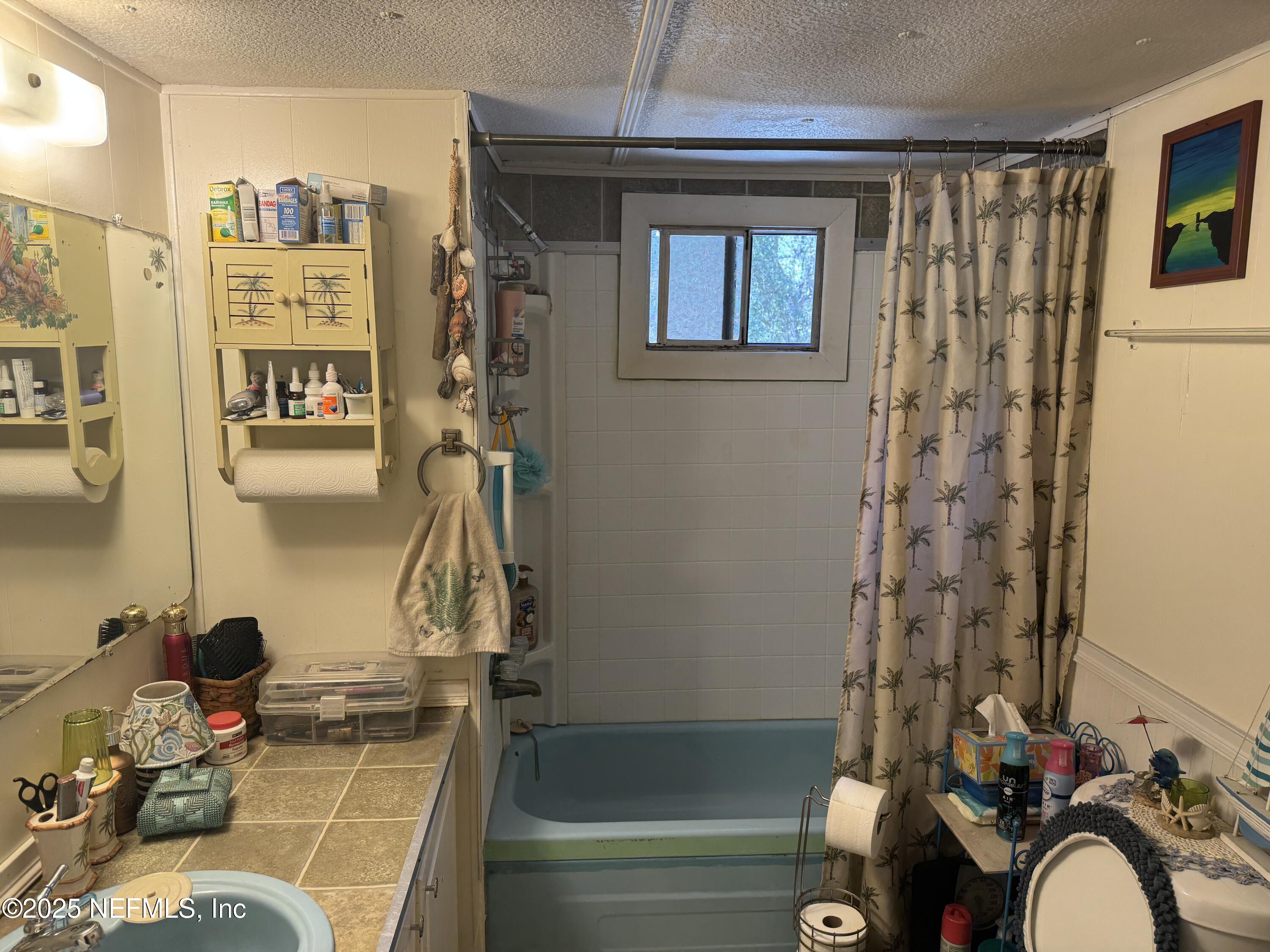 208 Lakeview Road Melrose, FL 32666 - Photo 18 of 22 a bathroom with a sink and a mirror