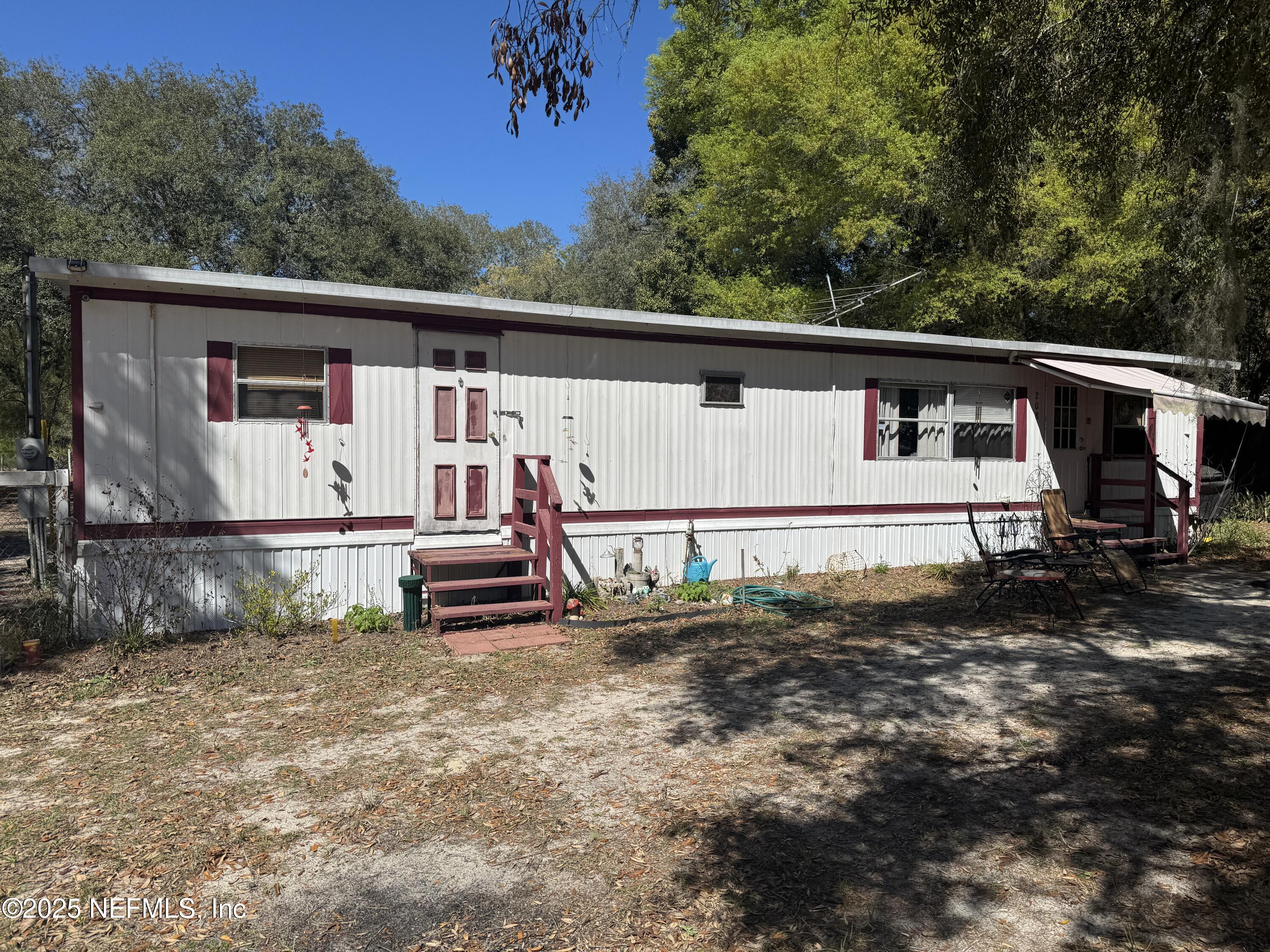 208 Lakeview Road Melrose, FL 32666 - Photo 2 of 22 a view of a small house with roof