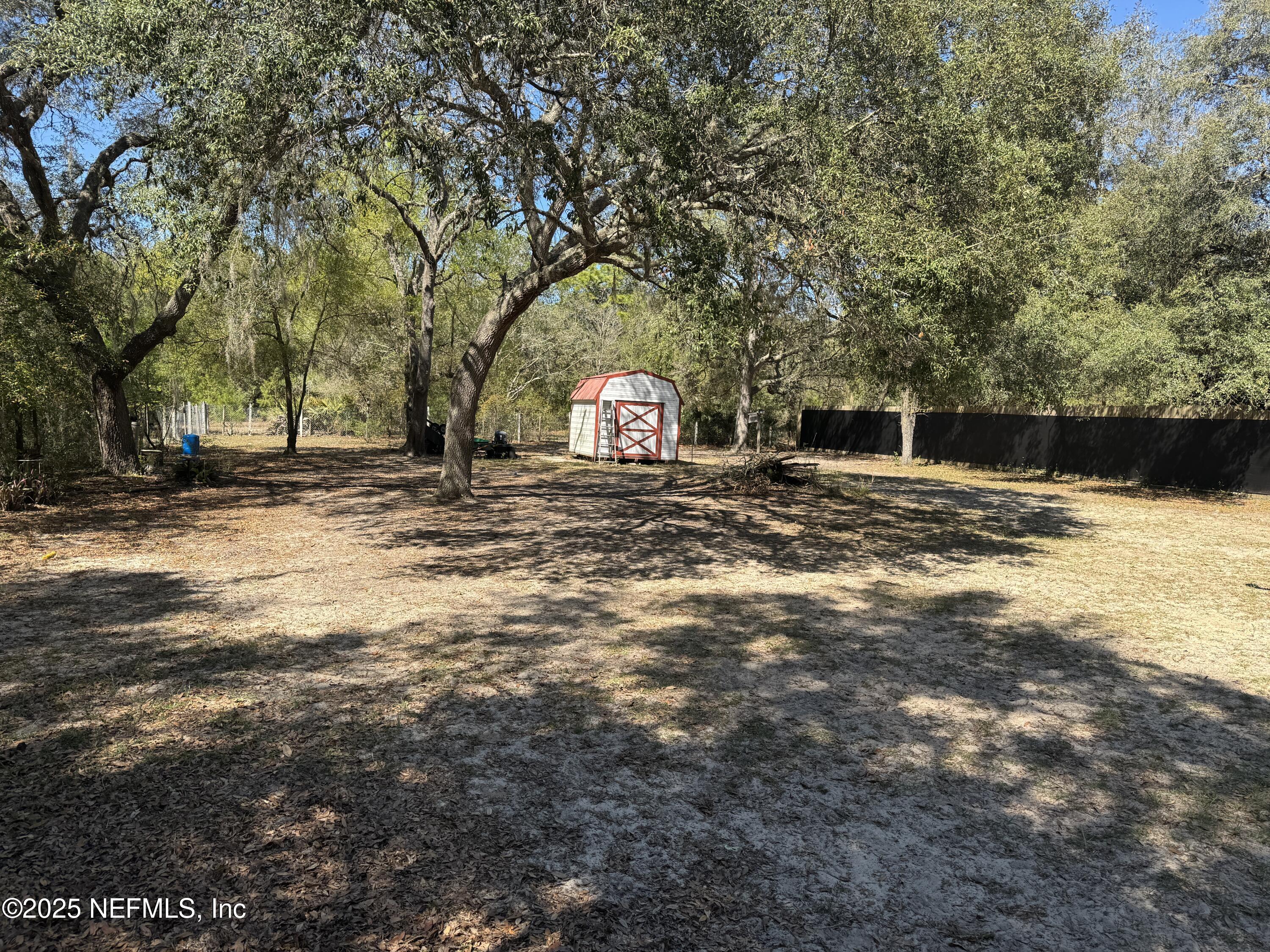 208 Lakeview Road Melrose, FL 32666 - Photo 22 of 22 a view of a yard with large trees