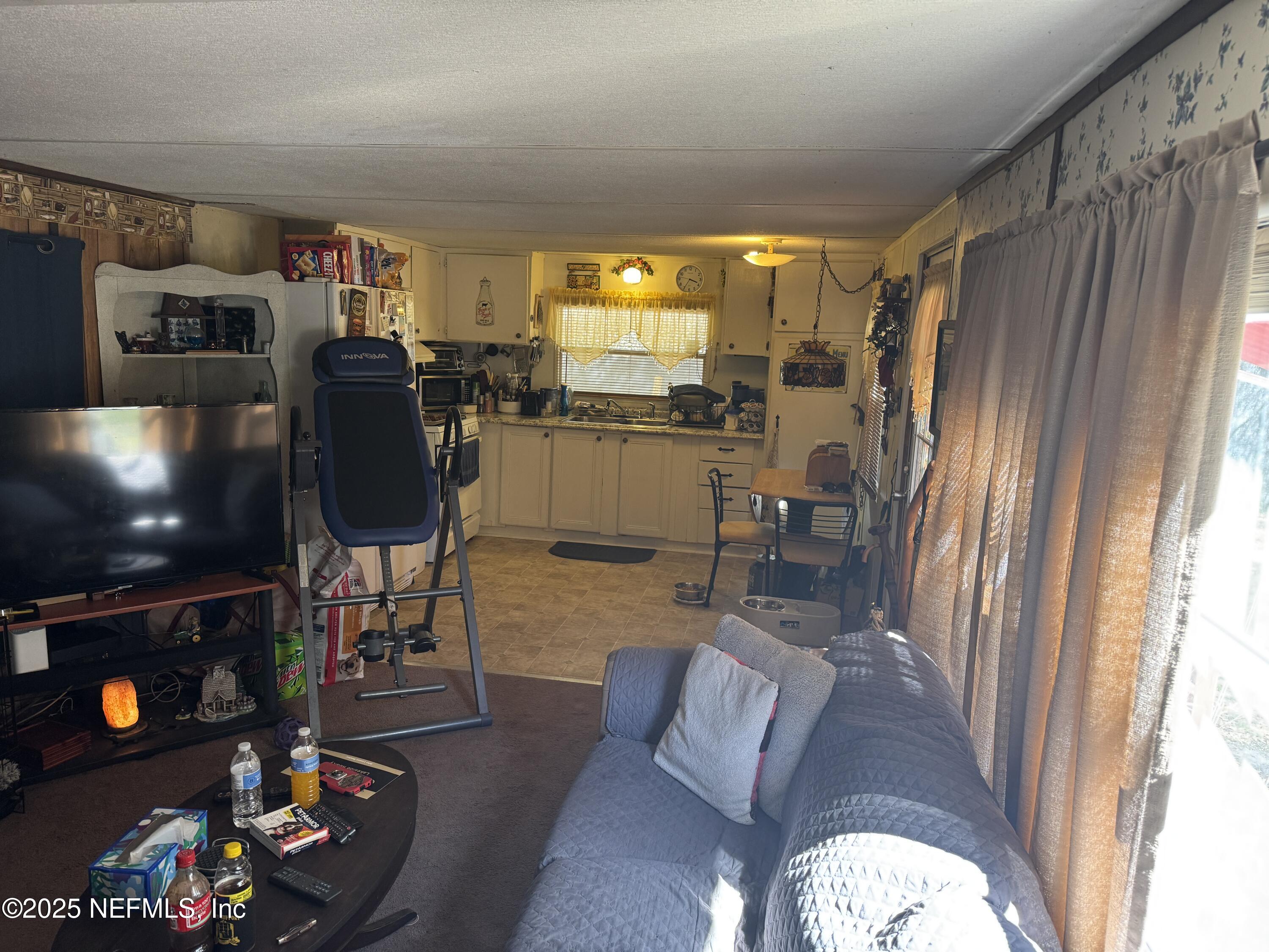 208 Lakeview Road Melrose, FL 32666 - Photo 5 of 22 a living room with furniture and a flat screen tv