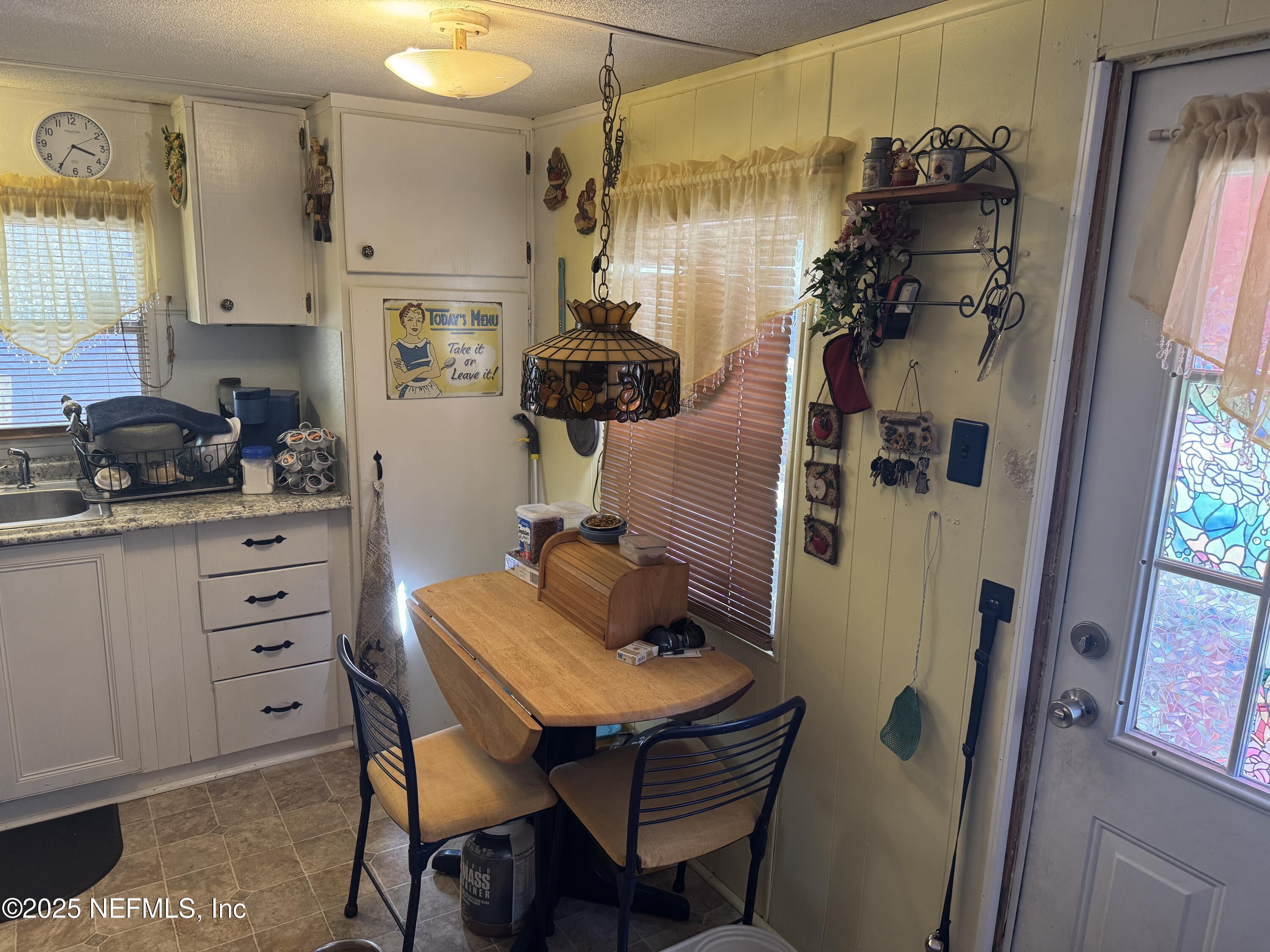 208 Lakeview Road Melrose, FL 32666 - Photo 9 of 22 a kitchen with a refrigerator and a stove top oven
