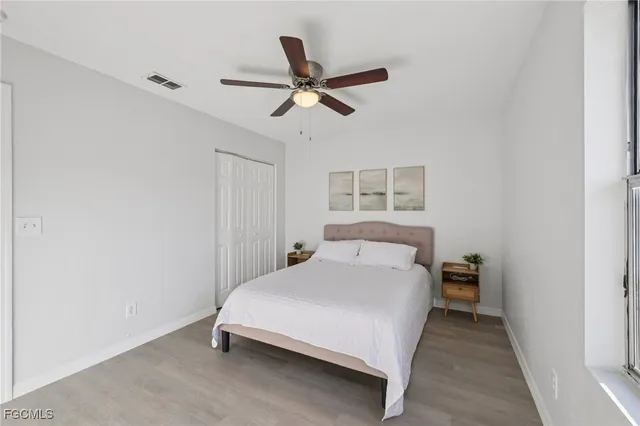 a bedroom with a bed and a ceiling fan